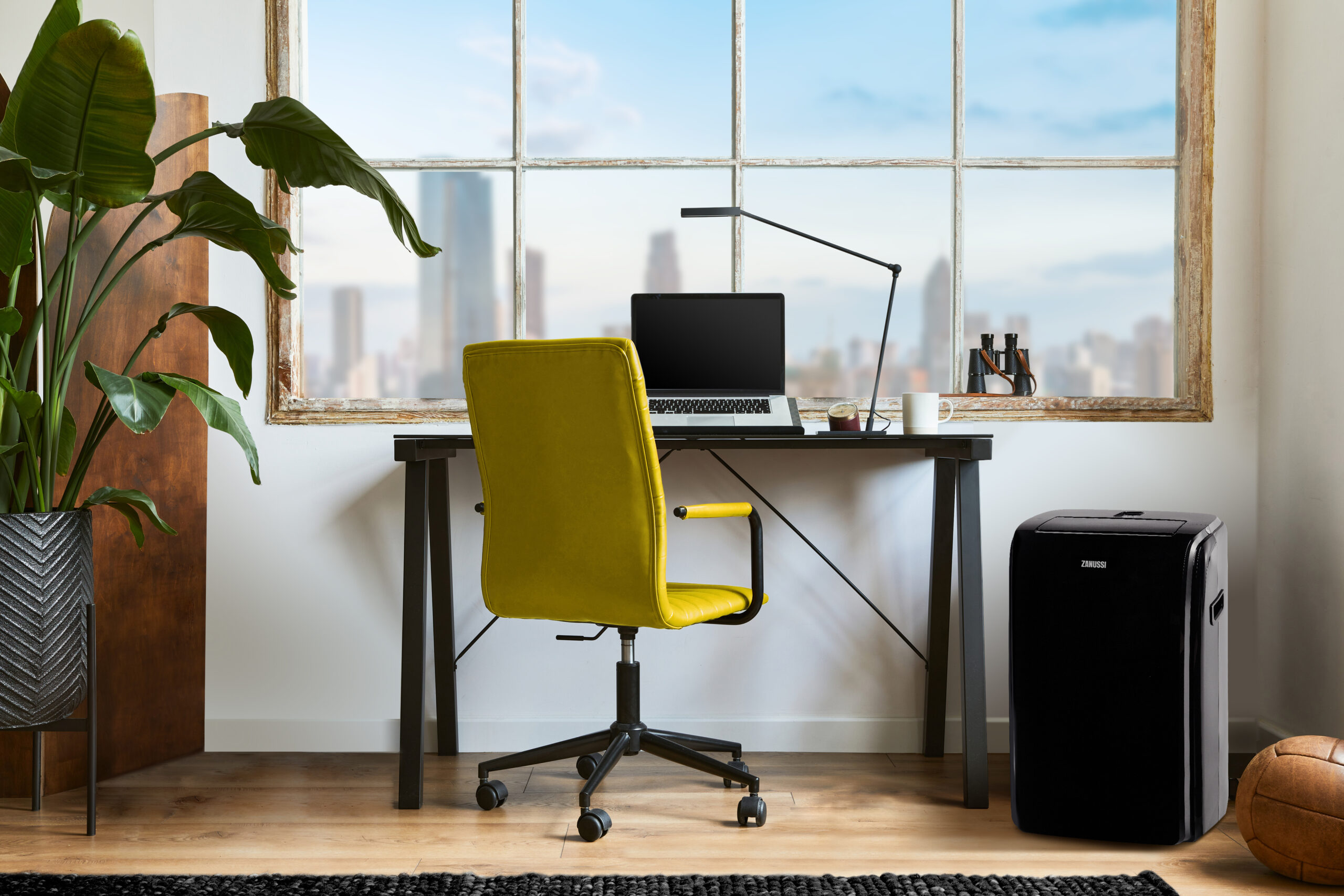 Creative workspace composition of modern masculine home office interior with black industrial desk, brown leather armchair, laptop, vintage record player and stylish personal accessories. Template.
